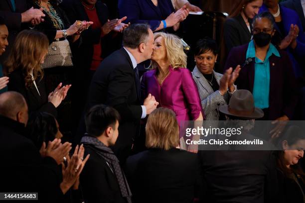 Second gentleman Doug Emhoff and First Lady Jill Biden greet each other with kiss as she arrives for U.S. President Joe Biden's State of the Union...