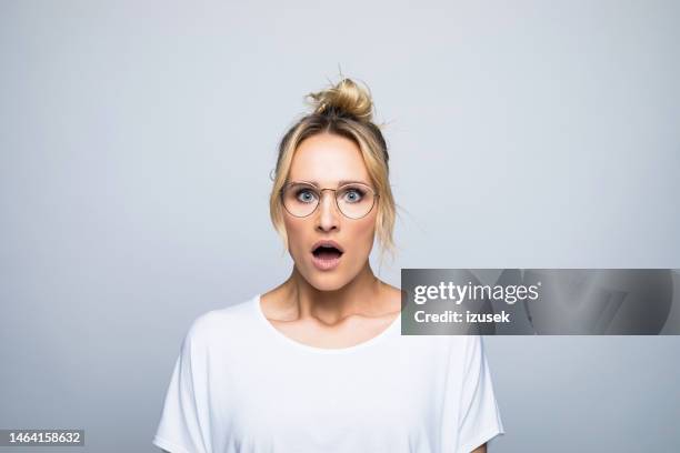 portrait of shocked woman with mouth open - upprörd bildbanksfoton och bilder