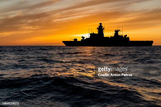 warship at sunset in the sea. fleet flagship - frigate stock-fotos und bilder