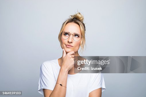 Thoughtful woman with hand on chin looking up