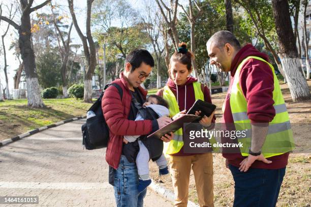 volunteers collecting signatures - petition stock pictures, royalty-free photos & images