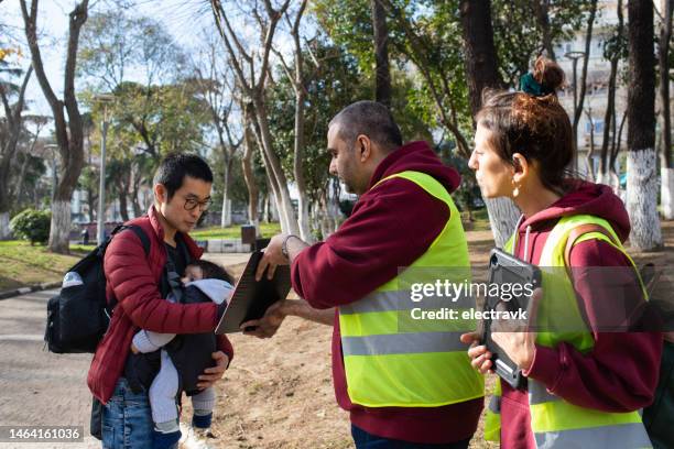 volunteers collecting signatures - signing petition stock pictures, royalty-free photos & images