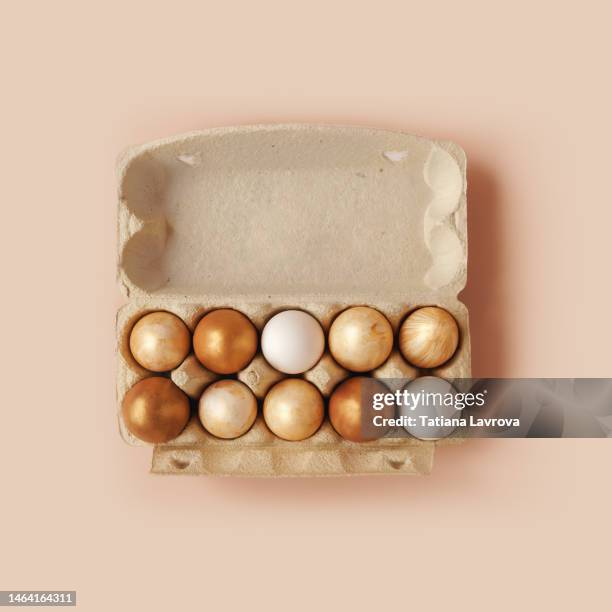 cardboard container with gold colored easter eggs on pastel beige background. fresh organic food in recyclable tray - easter concept stock pictures, royalty-free photos & images