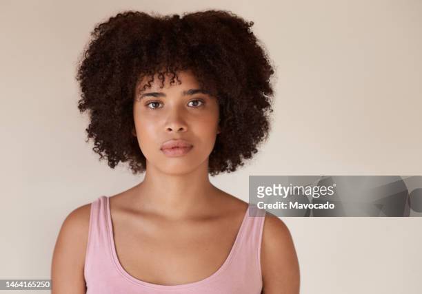 confident young african woman with perfect skin standing against a light background - woman portrait skin stock-fotos und bilder