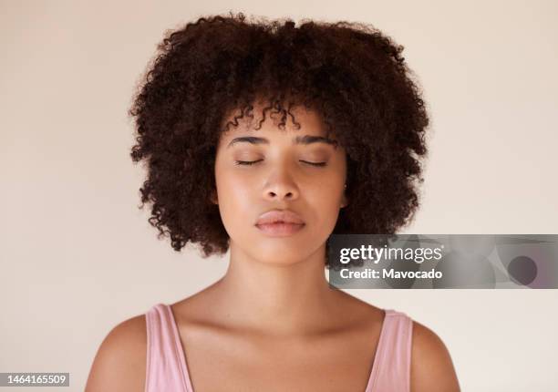 young african woman with a perfect complexion standing with her eyes closed - woman vest stock pictures, royalty-free photos & images