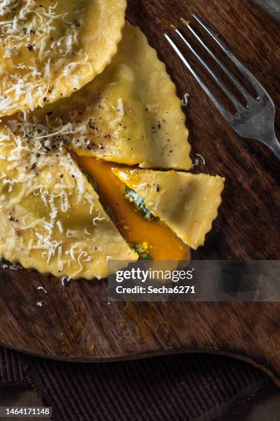 ravioli with spinach, ricotta and egg yolk an a rustic background - ricotta cheese stock pictures, royalty-free photos & images