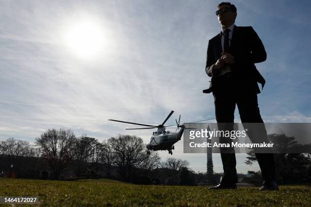 Secret Service agent stands on the South Lawn as Marine One carrying U.S. President Joe Biden lifts off from the White House on February 08, 2023 in...