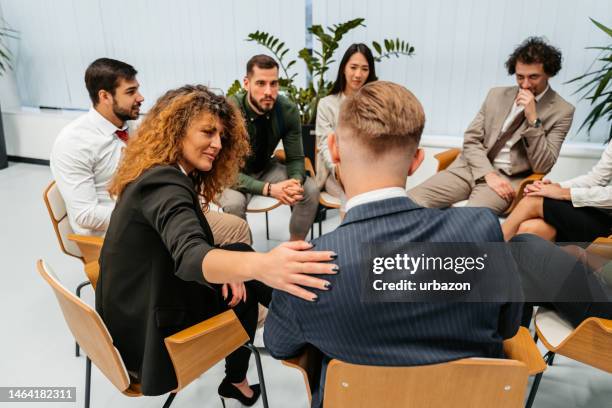 group of business colleagues having a group therapy session in the office - story telling in the workplace stock pictures, royalty-free photos & images