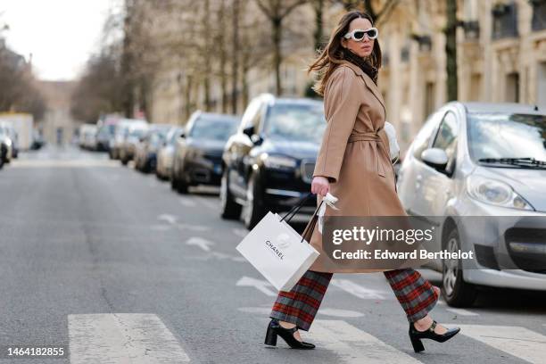 Maria Rosaria Rizzo wears a brown and black FF monogram print pattern wool scarf from Fendi, pale gray puffy sunglasses from Loewe, silver and gold...