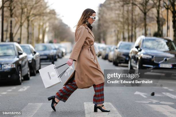 Maria Rosaria Rizzo wears a brown and black FF monogram print pattern wool scarf from Fendi, pale gray puffy sunglasses from Loewe, silver and gold...