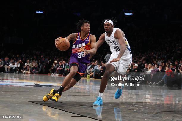 Saben Lee of the Phoenix Suns drives against Day'Ron Sharpe of the Brooklyn Nets during their game at Barclays Center on February 07, 2023 in New...