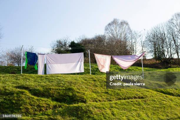 clothes hanging on a clothesline - dirty clothes stock pictures, royalty-free photos & images