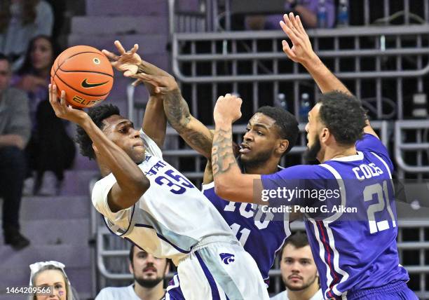 Nae'Qwan Tomlin of the Kansas State Wildcats gets pressured by JaKobe Coles and Rondel Walker of the TCU Horned Frogs, during a game in the first...