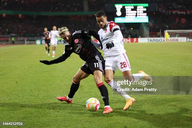 Jan Gyamerah of 1. FC Nürnberg battles for possession with Felix Klaus of Fortuna Düsseldorf during the DFB Cup round of 16 match between 1. FC...