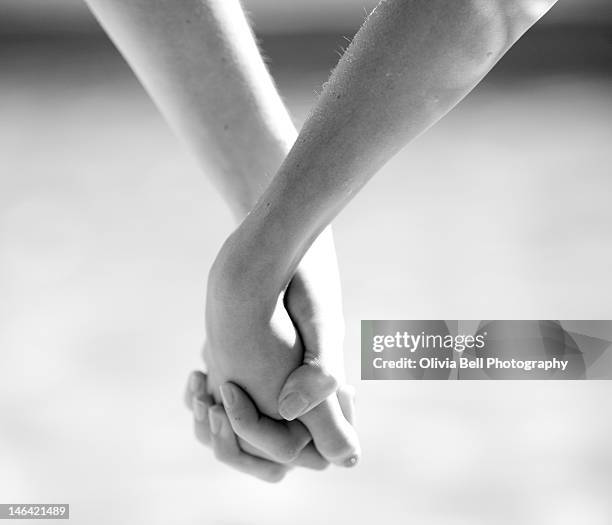 two sisters holding hands - black and white holding hands stock pictures, royalty-free photos & images