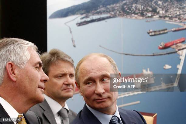 Russia's President Vladimir Putin and ExxonMobil Chairman and CEO Rex Tillerson attend at the ceremony of the signing of an agreement between...