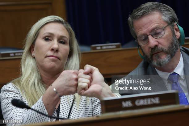Rep. Marjorie Taylor-Greene fist-bumps Rep. Tim Burchett during a hearing before the House Oversight and Accountability Committee at Rayburn House...