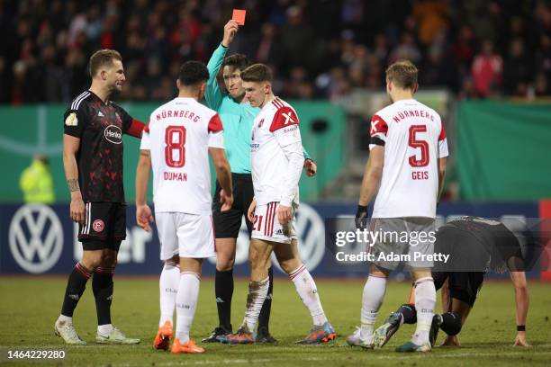 Florian Flick of 1. FC Nürnberg is shown a red card during the DFB Cup round of 16 match between 1. FC Nürnberg and Fortuna Düsseldorf at...