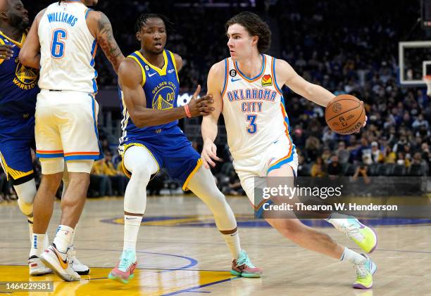 Josh Giddey of the Oklahoma City Thunder drives to the basket on Jonathan Kuminga of the Golden State Warriors during the thir quarter at Chase...