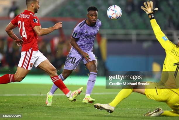 Vinicius Junior of Real Madrid scores the team's first goal as Mohammed El Shenawy of Al Ahly FC attempts to make a save during the FIFA Club World...