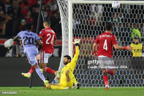 Vinicius Junior of Real Madrid scores the team's first goal as Mohammed El Shenawy of Al Ahly FC reacts after not making a save during the FIFA Club...
