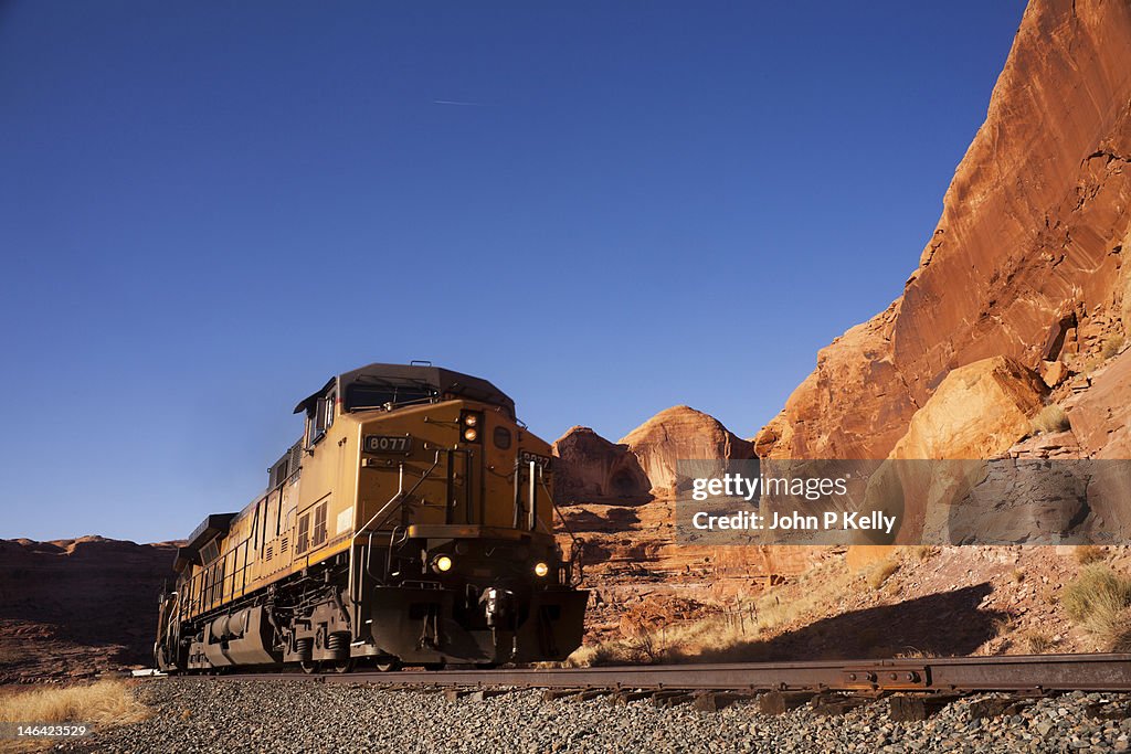 Locomotive traveling through red rock canyon