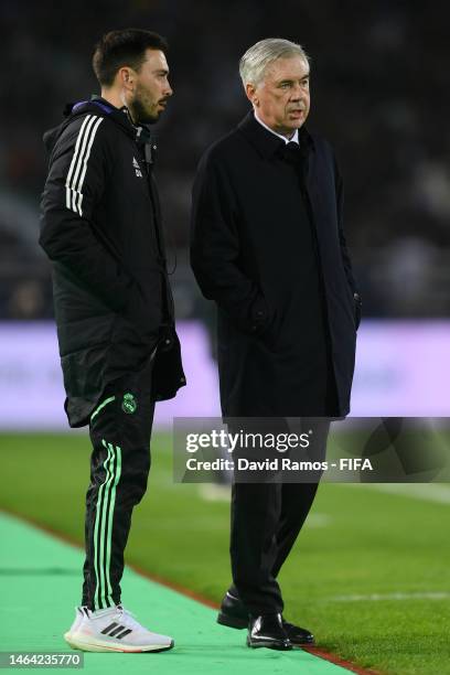 Carlo Ancelotti, Manager of Real Madrid, speaks with Davide Ancelotti during the FIFA Club World Cup Morocco 2022 Semi Final match between Al Ahly...