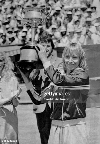 Martina Navratilova defeated Kathy Jordan and wins the Australian Open. Navratilova holds up trophy December 10, 1983.