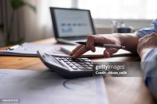 business accounting concept, business man using calculator with computer laptop, budget and loan paper in office. - accounting calculator stock pictures, royalty-free photos & images