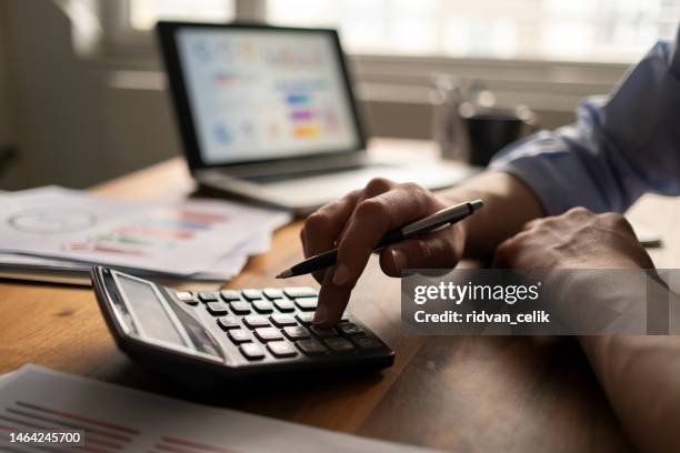 business accounting concept, business man using calculator with computer laptop, budget and loan paper in office. - calculator stock pictures, royalty-free photos & images