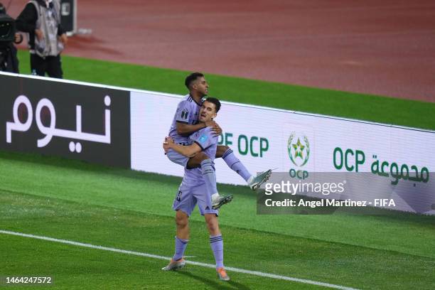 Rodrygo of Real Madrid celebrates with teammate Dani Ceballos after scoring the team's third goal during the FIFA Club World Cup Morocco 2022 Semi...