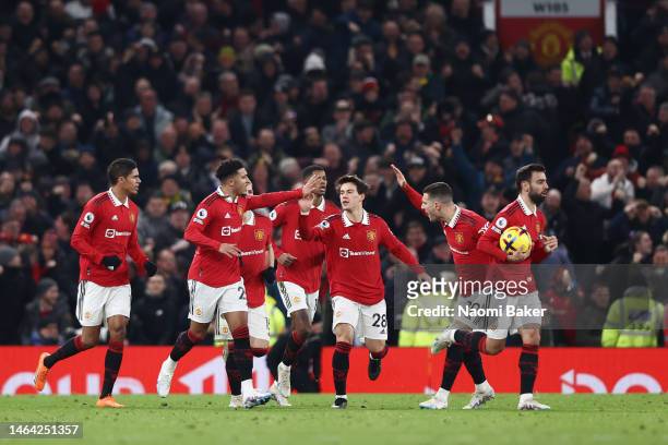 Jadon Sancho of Manchester United celebrates with teammates after scoring the team's second goal during the Premier League match between Manchester...