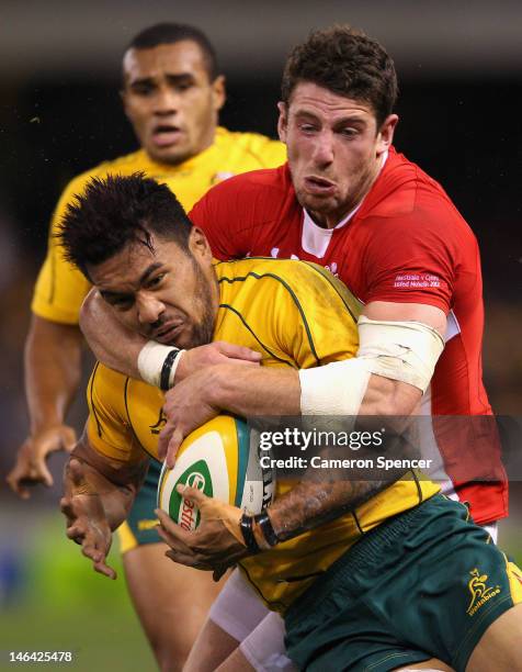 Digby Ioane of the Wallabies is tackled during the International Test Match between the Australian Wallabies and Wales at Etihad Stadium on June 16,...