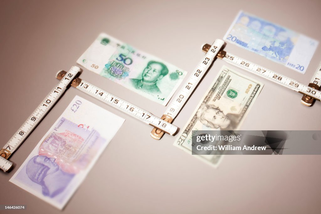 Various paper currencies being measured