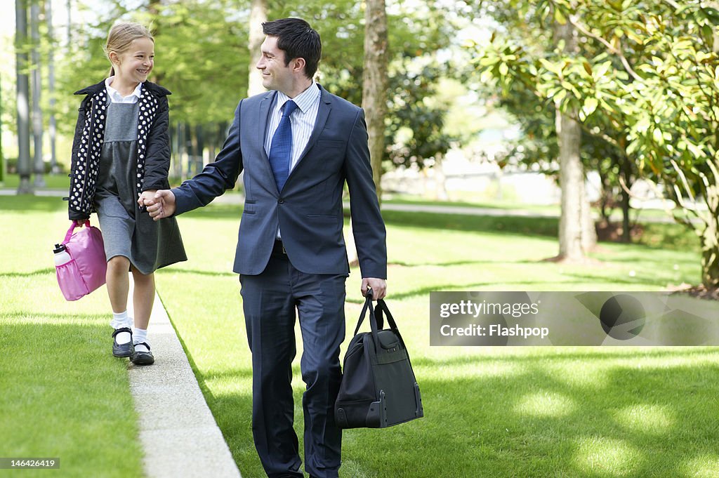 Father walking his daughter to school