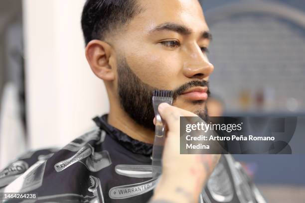 barber applying beard dye - beard stock pictures, royalty-free photos & images