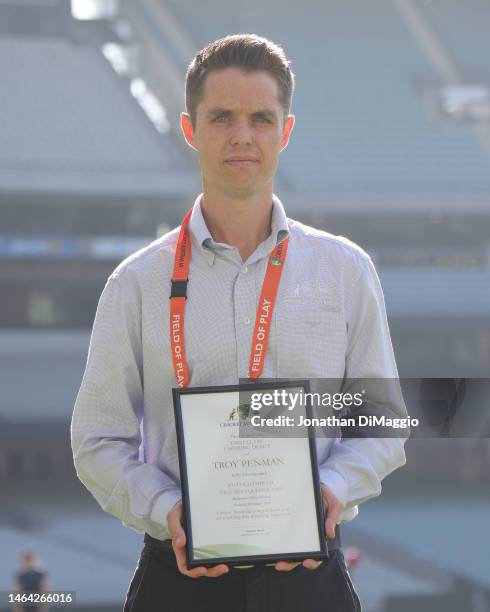 Umpire Troy Penman is presented with a certificate as he makes his first class cricket debut during the Sheffield Shield match between Victoria and...