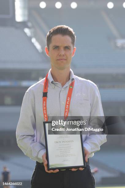 Umpire Troy Penman is presented with a certificate as he makes his first class cricket debut during the Sheffield Shield match between Victoria and...