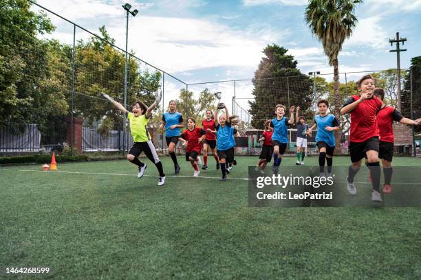 junge spielermannschaft feiert erfolg - mixed age range stock-fotos und bilder