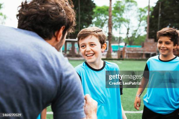 young soccer team training together in a mixed boys and girls group - youth sports training stock pictures, royalty-free photos & images