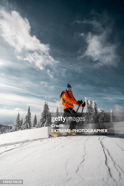 a female adventurer seen ski touring in a magical nature - skischoen stockfoto's en -beelden