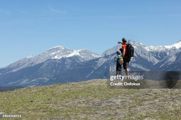 father and son hiking at the old fort point hiking trail, jasper, alberta, canada - mountain ridge stock pictures, royalty-free photos & images