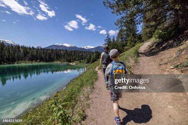 family hiking at valley of the five lakes trail, jasper, canada - jasper canada stock pictures, royalty-free photos & images