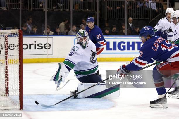 Alexis Lafrenière of the New York Rangers shoots past goaltender Spencer Martin of the Vancouver Canucks to score during the 2nd period of the game...