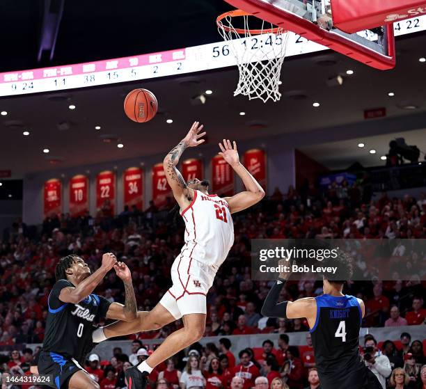 Emanuel Sharp of the Houston Cougars is fouled by Jesaiah McWright of the Tulsa Golden Hurricane as he drives to the basket fopr a layup during the...