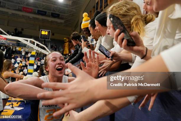 Jordan King of the Marquette Golden Eagles celebrates with fans after defeating the UConn Huskies 59-52 at Al McGuire Center on February 08, 2023 in...