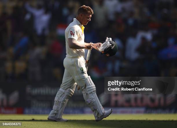 David Warner of Australia walks off after he was dismissed by Mohammed Shami of India during day one of the First Test match in the series between...