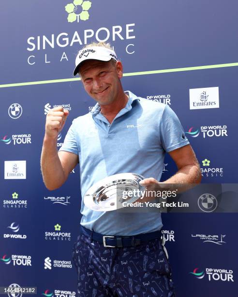 Marcel Siem of Germany receives a trophy to commemorate his 500th tour appearance during Day One of the Singapore Classic at Laguna National Golf...