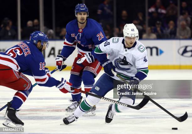 Vincent Trocheck of the New York Rangers and Elias Pettersson of the Vancouver Canucks battle for the puck during the game at Madison Square Garden...