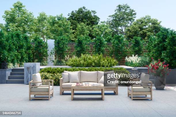 modern patio with sofa, armchairs, coffee table and garden view background - landscaped stock pictures, royalty-free photos & images